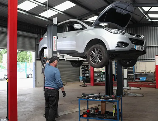 car lifted onto a hydraulic ram in the onsite service